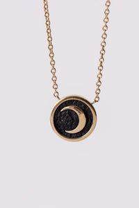 Miles McNeel 14k gold small circular celestial crescent moon necklace with blackened concrete 