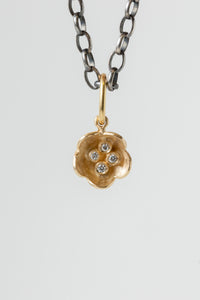 Erica Molinari mixed metal two tone 14k yellow gold and oxidized sterling silver tiny flower pendant with 4 white diamonds detailing the center, a micro floral charm for layering